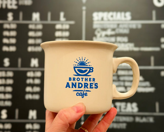 Classic ceramic diner-style mug in cream featuring Brother Andre's Cafe blue logo